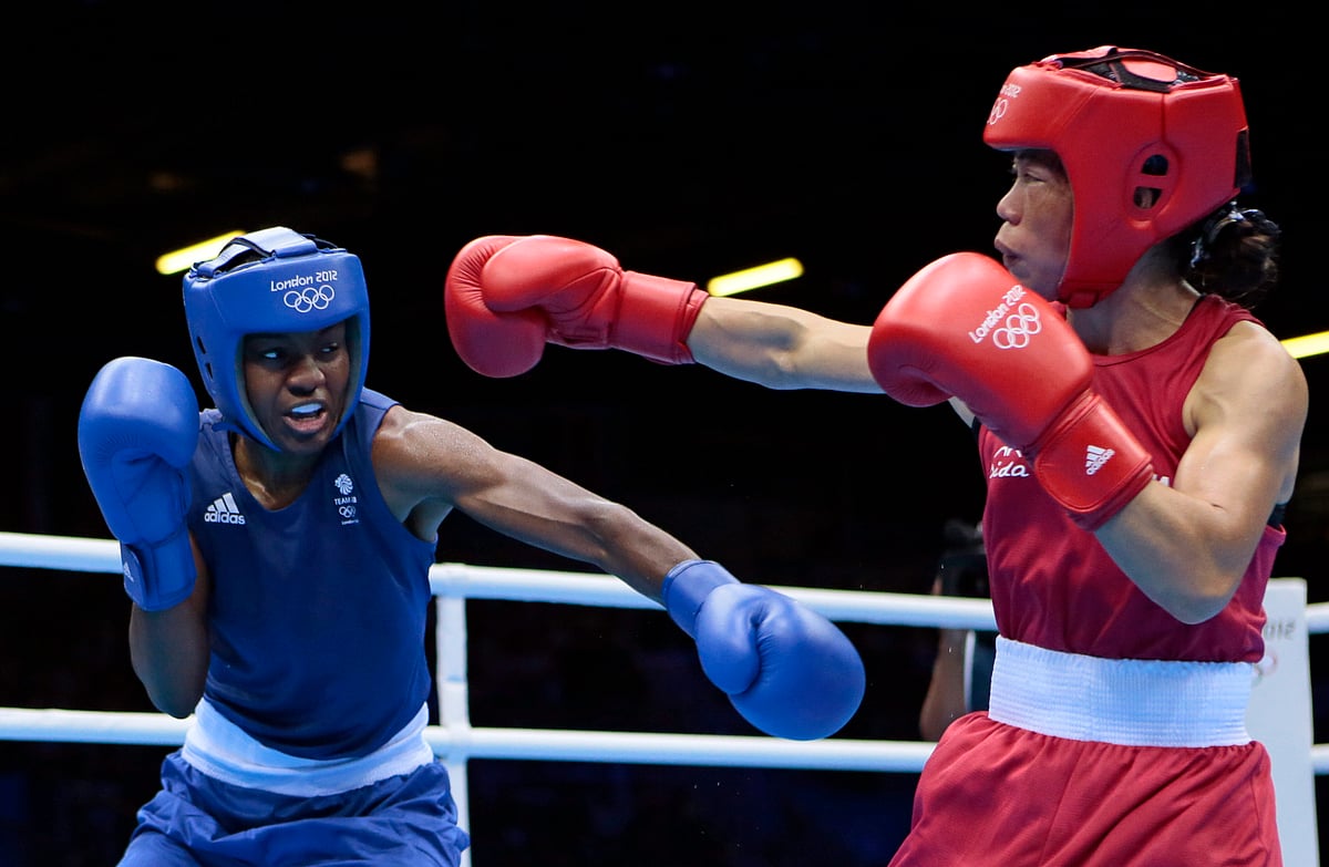  (AP Photo/Ivan Sekretarev, File) : FILE - Britain's Nicola Adams, left, and India's Chungneijang Mery Kom Hmangte fight during their women's flyweight 51-kg semifinal boxing match at the 2012 Summer Olympics, Wednesday, Aug. 8, 2012, in London. Just 12 years after women’s boxing debuted at the Olympics in only three weight classes, half of the boxers in Paris will be women in a field that’s deeper and more talented than ever.